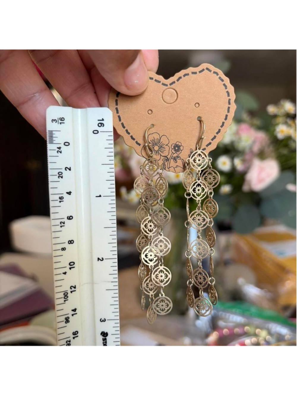 Long Gold tone earrings with floral motif